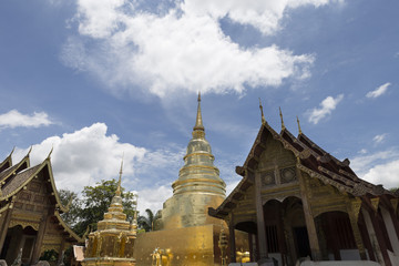 Naklejka premium golden pagoda and sanctuary in buddhism temple with leaves frame