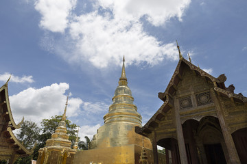 Naklejka premium golden pagoda and sanctuary in buddhism temple with leaves frame