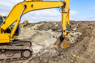 Excavator and bulldozer with caterpillars at building site