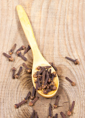 Cloves on a wood board.