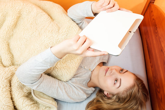 Young woman girl with tablet browsing internet.