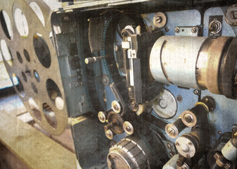 Old and antique commercial movie projector. Vintage projector. Mechanism of the aged theater projector