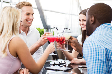 Positive friends sitting in the cafe