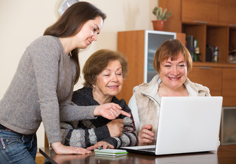 Fototapeta premium Female and relative working on laptop