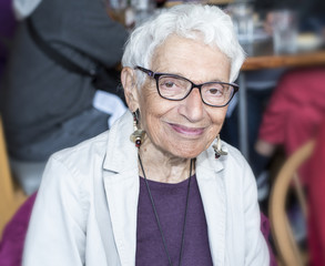 Independent Older Woman at Restaurant Smiling & Happy