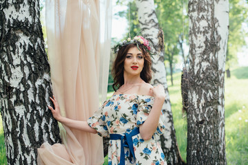 Beautiful Russian girl in the decoration on the nature