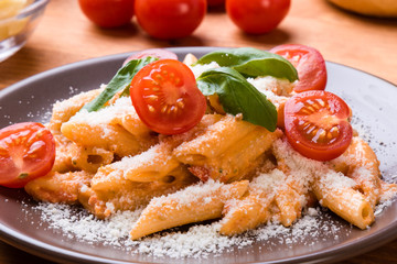 penne with tomato in brown plate