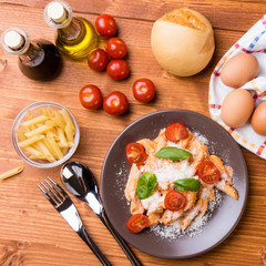 penne with tomato in brown plate