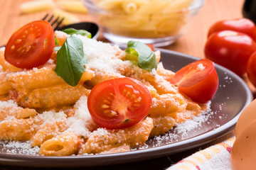 penne with tomato in brown plate