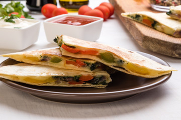quesadilla slices on brown plate