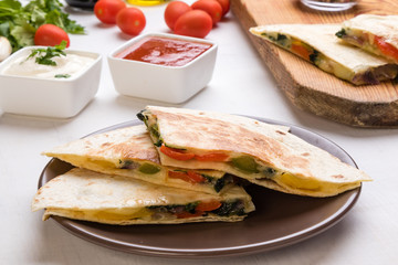 quesadilla slices on brown plate