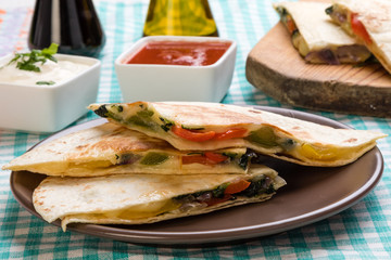 quesadilla slices on brown plate