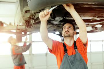 Car mechanic upkeeping car