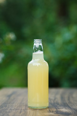 homemade lemonade in glass bottle on bokeh background