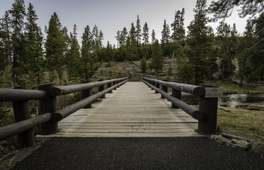 Fototapeta na wymiar Bridge across the river of Old Faithful at Yellowstone