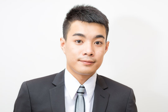 Asian handsome smart young business man on black suit smilling