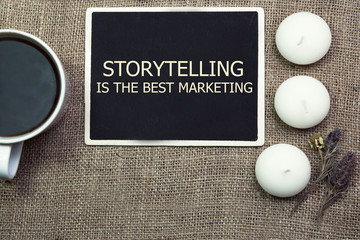 sentence Storytelling is the best Marketing, written with chalk on a blackboard, on a table with...