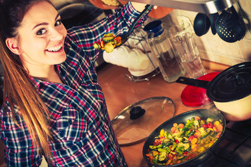 Woman frying frozen vegetables. Stir fry.