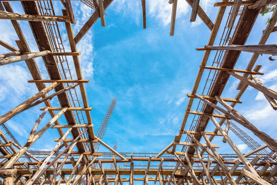 Wooden scaffolding at building site, Wooden scaffolding low angle view with blue sky background