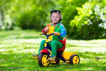 Little boy on colorful tricycle