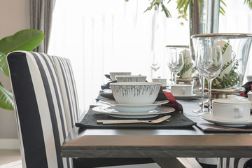 table set on wooden table in luxury dining room