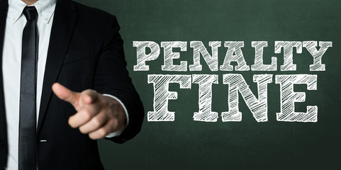 Business man pointing with the text: Penalty Fine