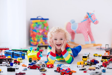 Little boy playing with toy cars