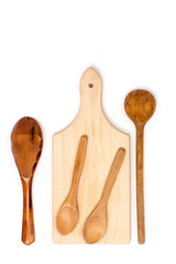 Kitchen wooden cutting board and wooden spoons flat lay