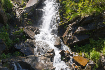 Beautiful waterfall in the mountains during the summer.