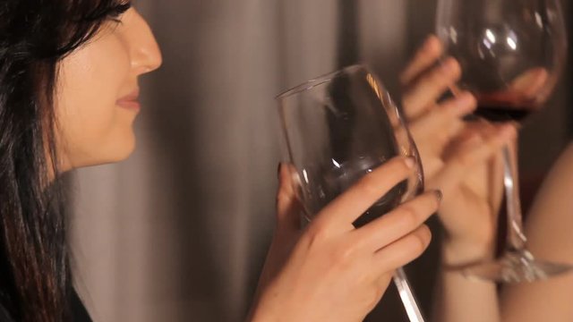Girls Drink Red Wine Beautiful young woman drinking red wine. Close up video footage of beauty lady with glass of wine.