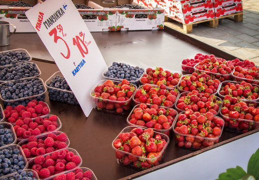 At the town market to sell strawberries and raspberries, blueberries and cherries.