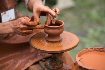 hands of a potter, creating an earthen jar
