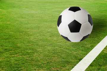 Soccer ball on green field