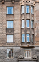 Several windows in a row and bay window on facade of urban office building front view, St. Petersburg, Russia.