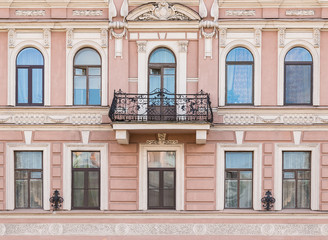 Obraz premium Several windows in a row and balcony on facade of urban apartment building front view, St. Petersburg, Russia.