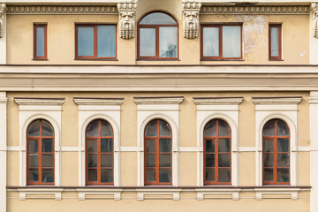 Several windows in a row on facade of urban office building front view, St. Petersburg, Russia.