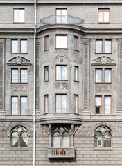 Several windows in a row and bay window on facade of urban apartment building front view, St. Petersburg, Russia.