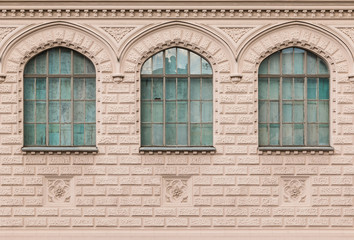 Fototapeta na wymiar Several windows in a row on facade of film studio building front view, St. Petersburg, Russia.