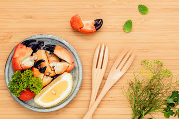 Fresh steamed red crabs leg in bowl . Red crabs leg with ingredi