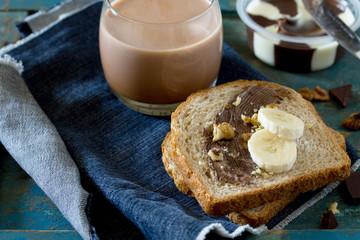 Cooking breakfast, toast bread with nut paste, chocolate and coc