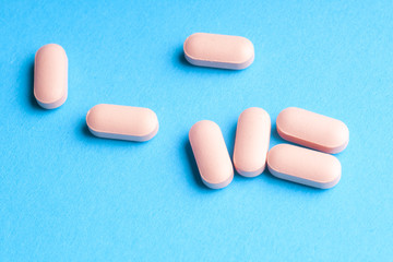 Many pills and tablets isolated on light blue background