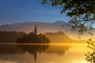 Fototapeta na wymiar magical sunrise of Lake Bled with island