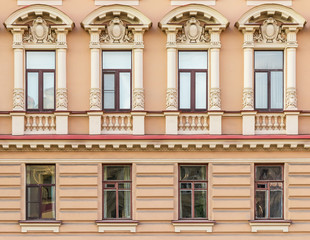 Obraz premium Several windows in a row on facade of urban apartment building front view, St. Petersburg, Russia.