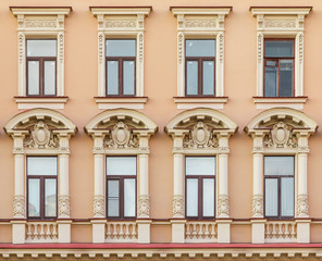 Fototapeta na wymiar Several windows in a row on facade of urban apartment building front view, St. Petersburg, Russia.