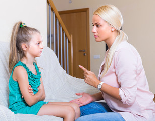 Woman scolding little daughter
