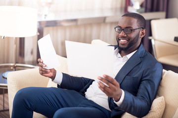 Man in suit holding documents