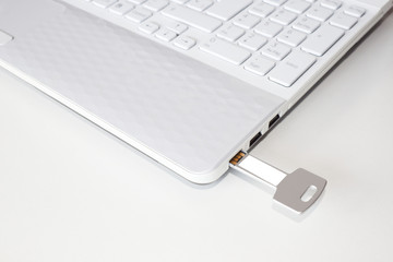 key pendrive in the usb port of a laptop
