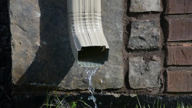Rain falling out of gutter - straight on
