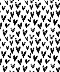 Vector seamless pattern with hand drawn doodle black small hearts.