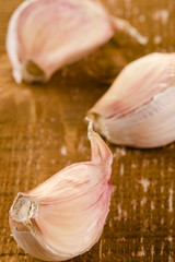 Garlic cloves on wooden background